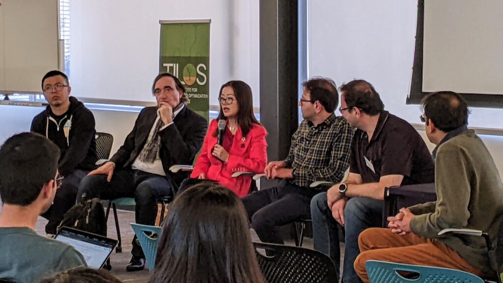 A panel of AI researchers participating in a discussion at a workshop at UC San Diego